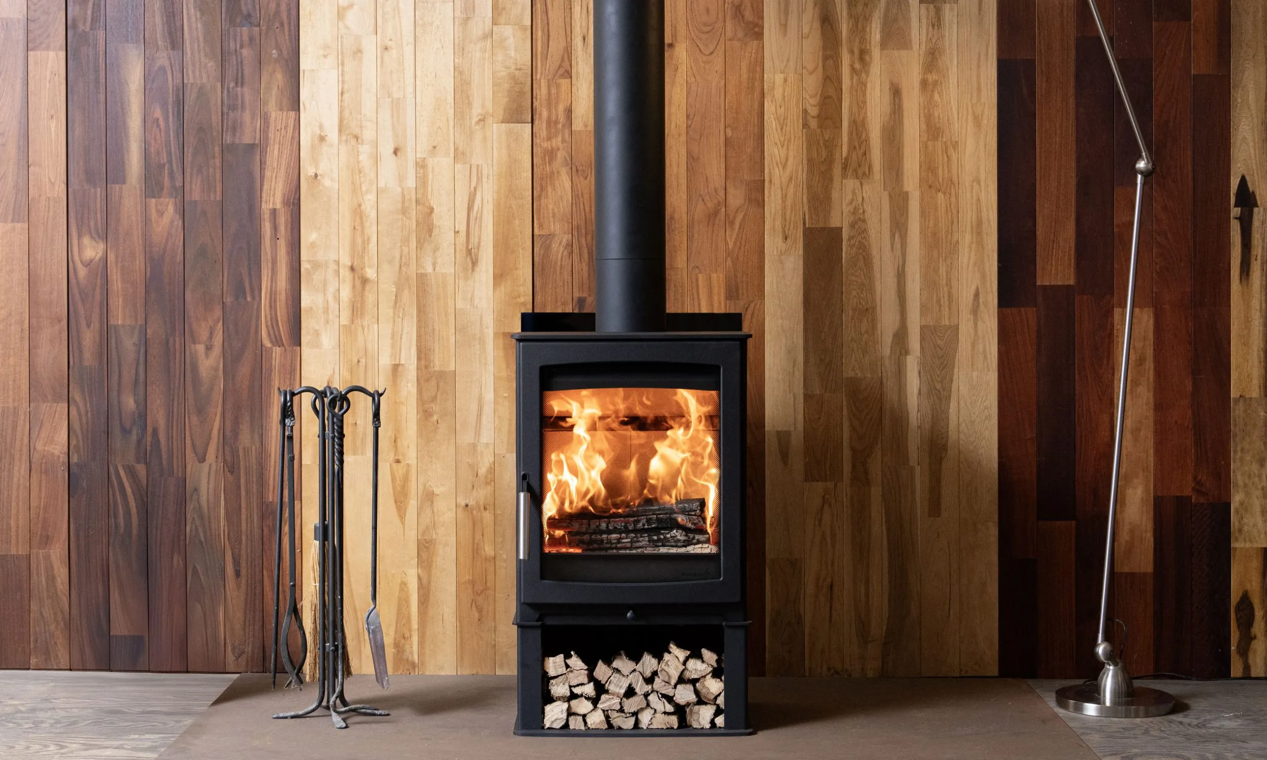 Parkray Aspect 5 Eco wood heater installed against a timber feature wall
